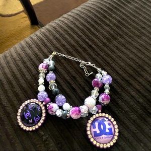 Pretty purple handmade bracelet with bling tray charms.